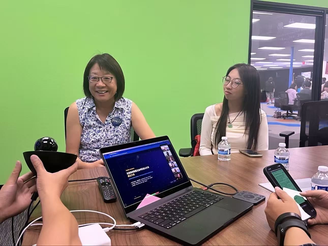 Ping Li (left) interacting with attendees at the ceremony