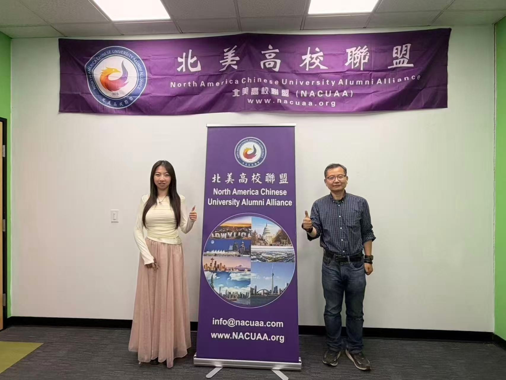 Attendees posing in front of the NACUAA banner